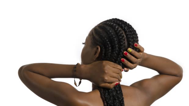 Black woman with long cornrows from the back