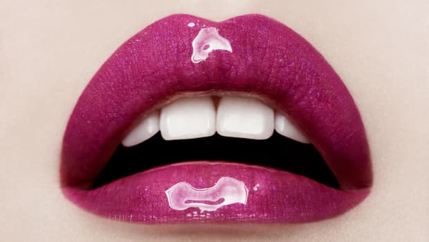 a close up of purple glossy lips