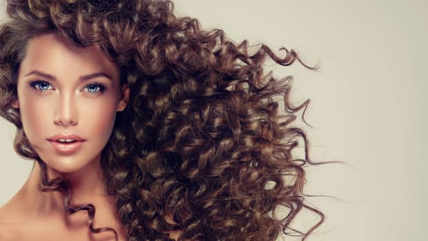 a woman with long, brown, curly hair