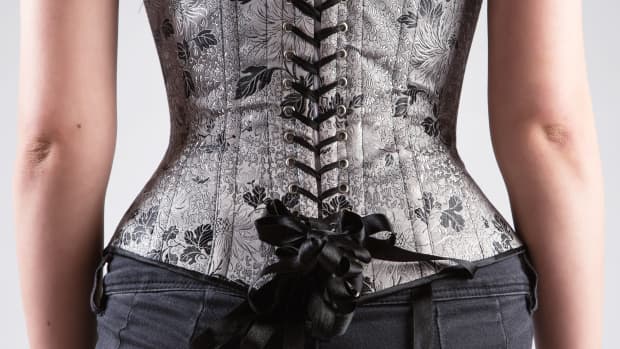 the back of a silver and black corset top