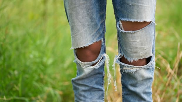 a close up of distressed jeans