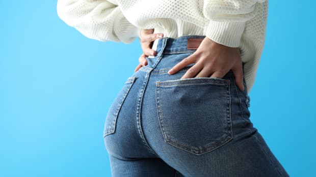 a close up of a woman in jeans from the back