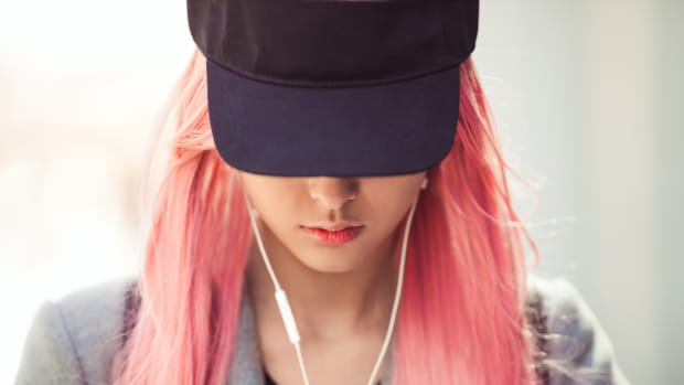 girl with pink hair listening to music