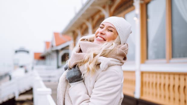 woman smiling outside in winter wear