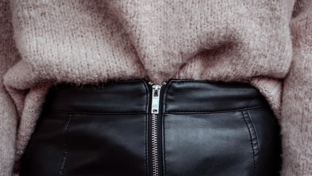 close up of a woman with a leather skirt on