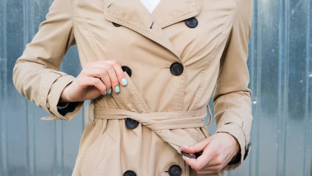 woman tying a trench coat