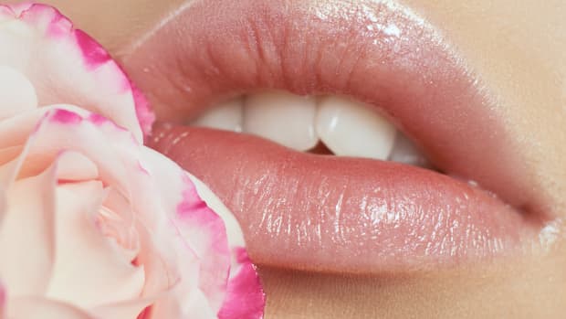 natural lips close up with a rose on the side