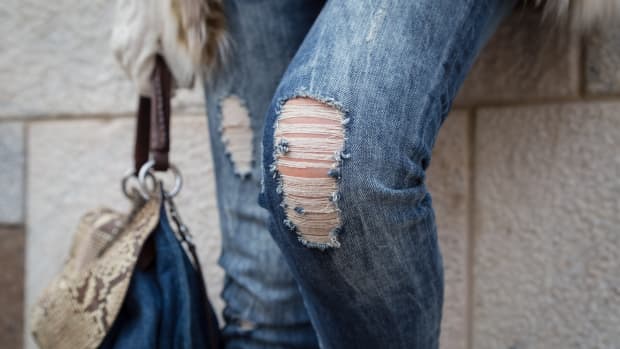 a woman's knees in distressed jeans