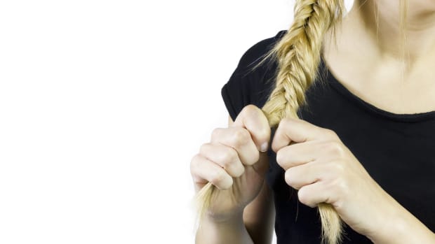 woman braiding her hair