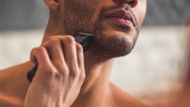 man shaving his face
