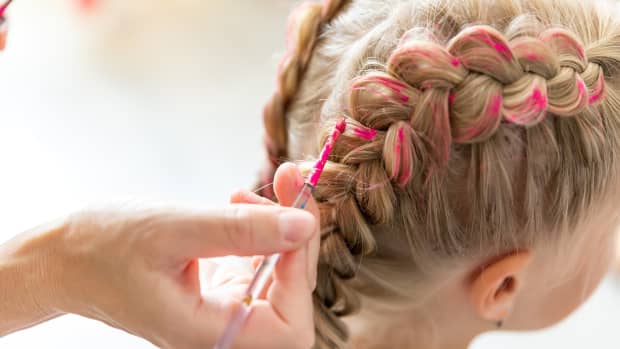 a little girl with pink in her French braids