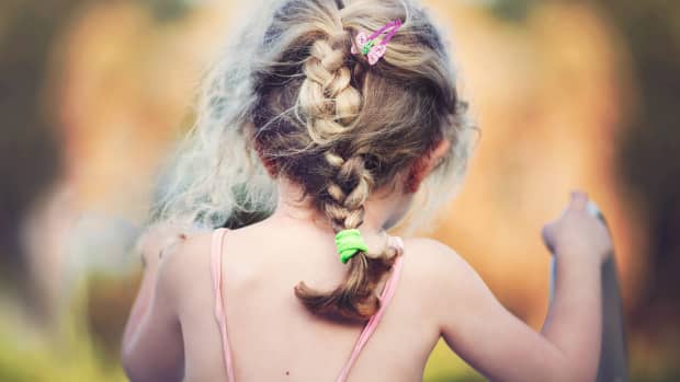 toddler with a braid in her hair.
