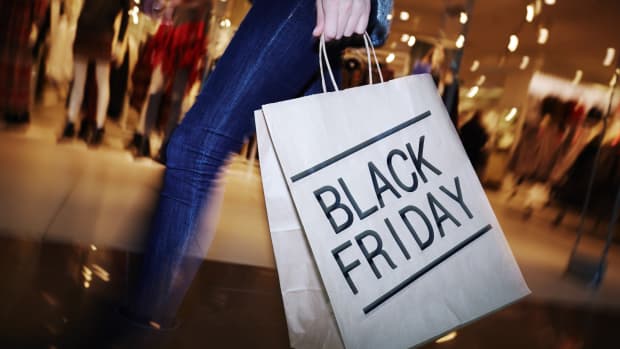 a woman with a Black Friday shopping back
