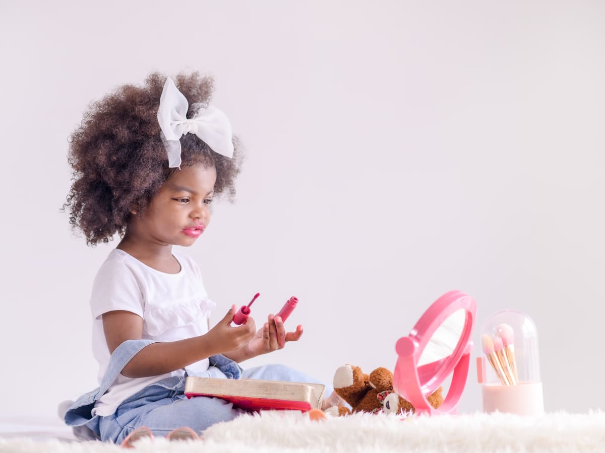 Baby playing shop with makeup