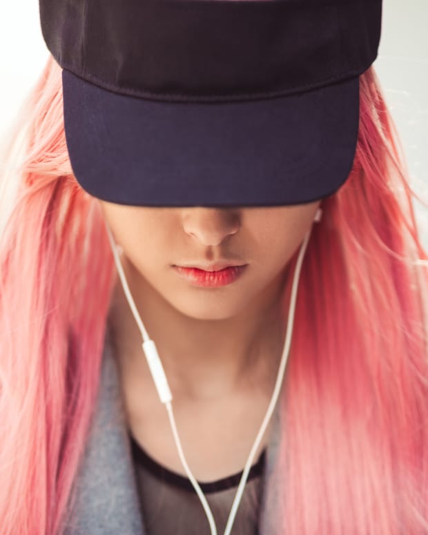 girl with pink hair listening to music