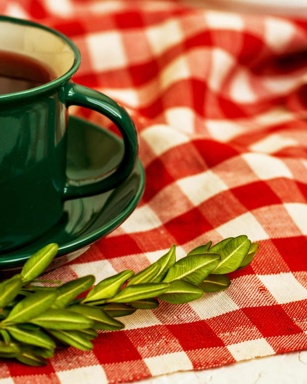 a checkered tablecloth with a coffee mug on it