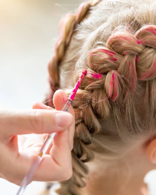 a little girl with pink in her French braids